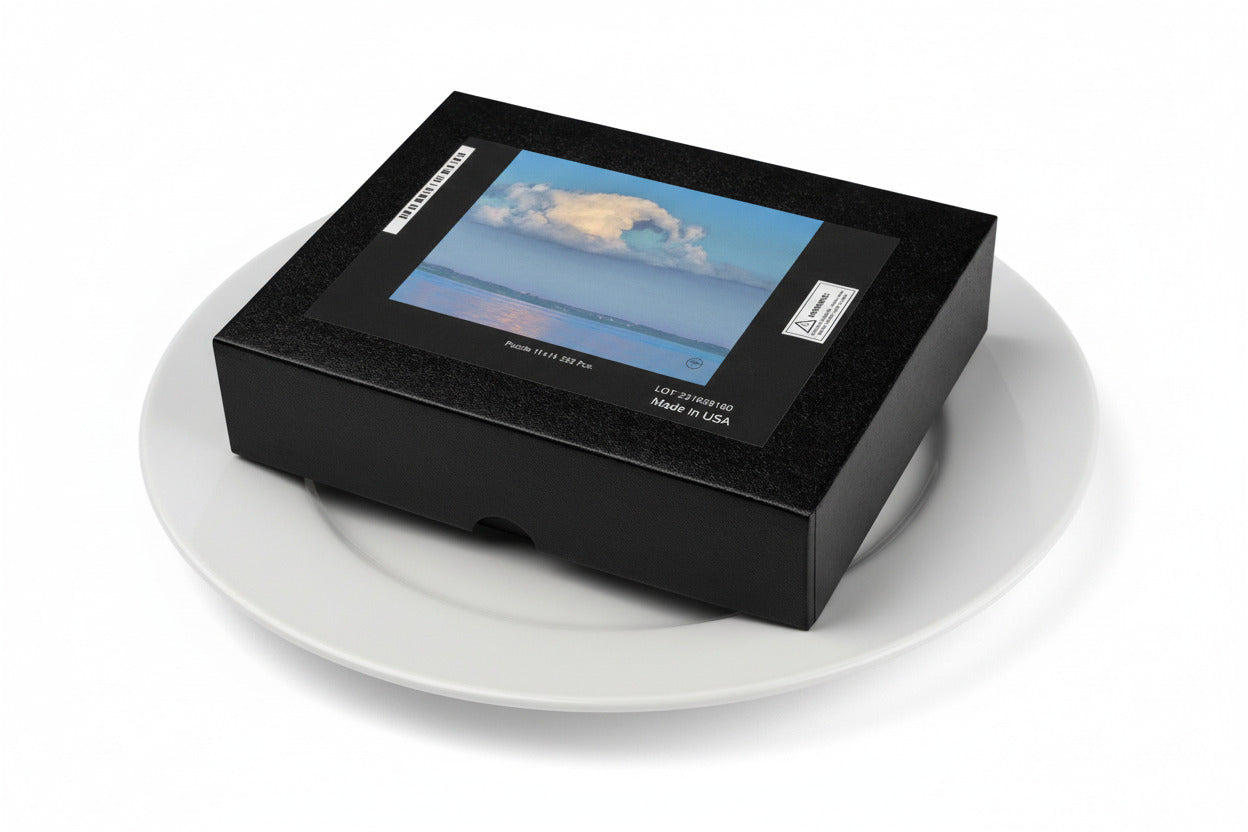 Your Suggested Brand Jigsaw Puzzle Box displaying an image of a cloud over water on a dinner plate. Serving size 1 puzzle and it's calorie free.