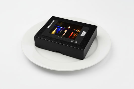 Your Suggested Brand jigsaw puzzle box on a dinner plate. Serving size one puzzle and it's calorie free. 